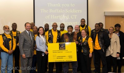 Buffalo Soldiers Motorcycle Club of Hartford presents a donation to sickle cell anemia research at UConn Health. 