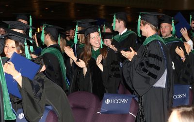 Members of the UConn School of Medicine Class of 2015 cheer during commencement exercises. (John Atashian for UConn Health) Click on the photo above to see the UConn Health commencement photo gallery.